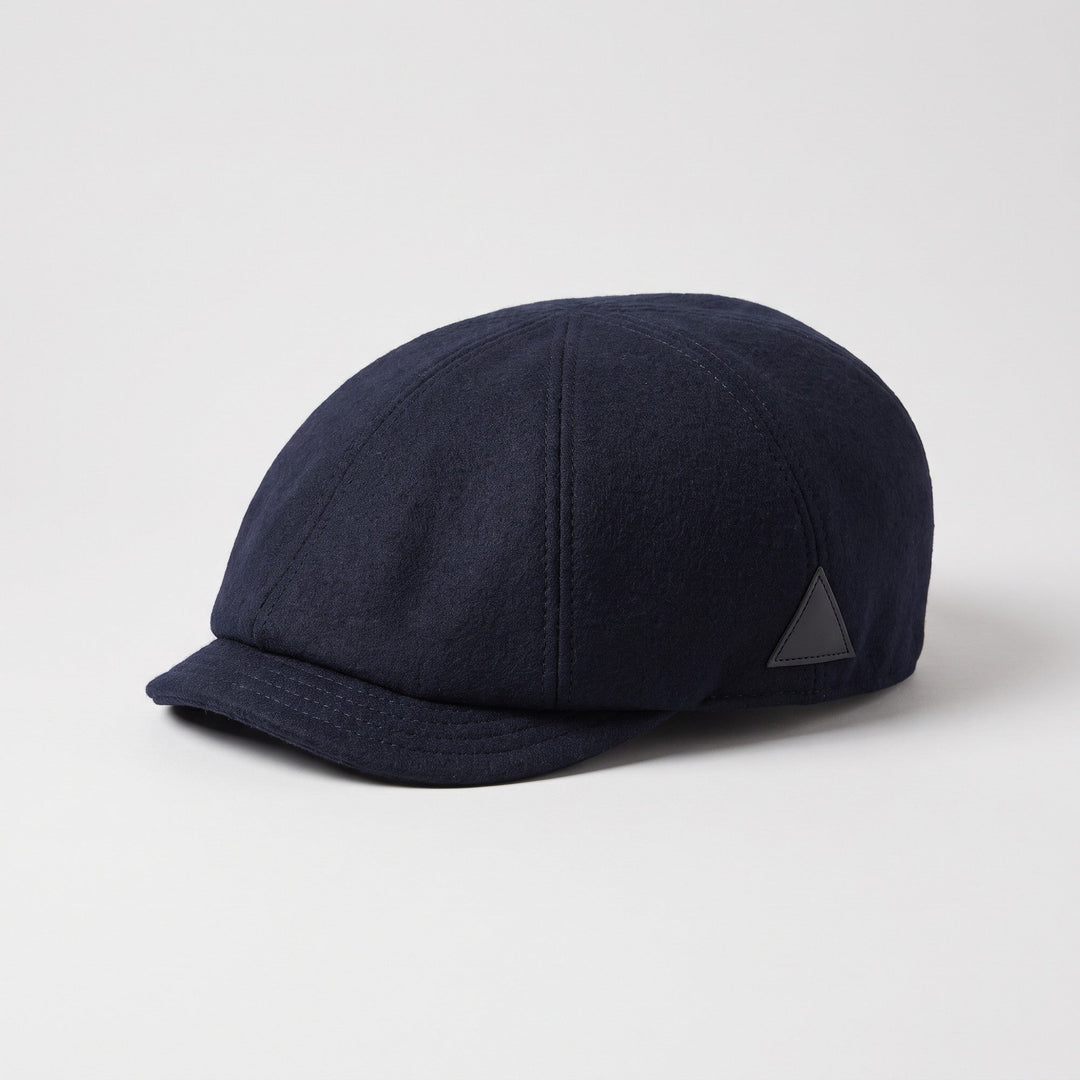 Navy blue wool flat cap, three-quarter view