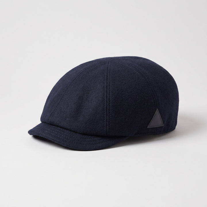 Navy blue wool flat cap, three-quarter view